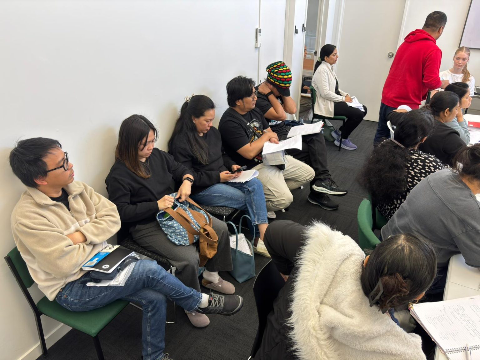 International nurses attending IQN and OSCE briefing session in New Zealand classroom setting