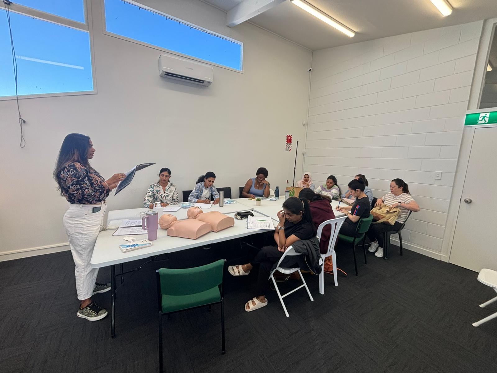 Indian nurses attending OSCE training class in New Zealand with practical nursing mannequins and instructor guidance
